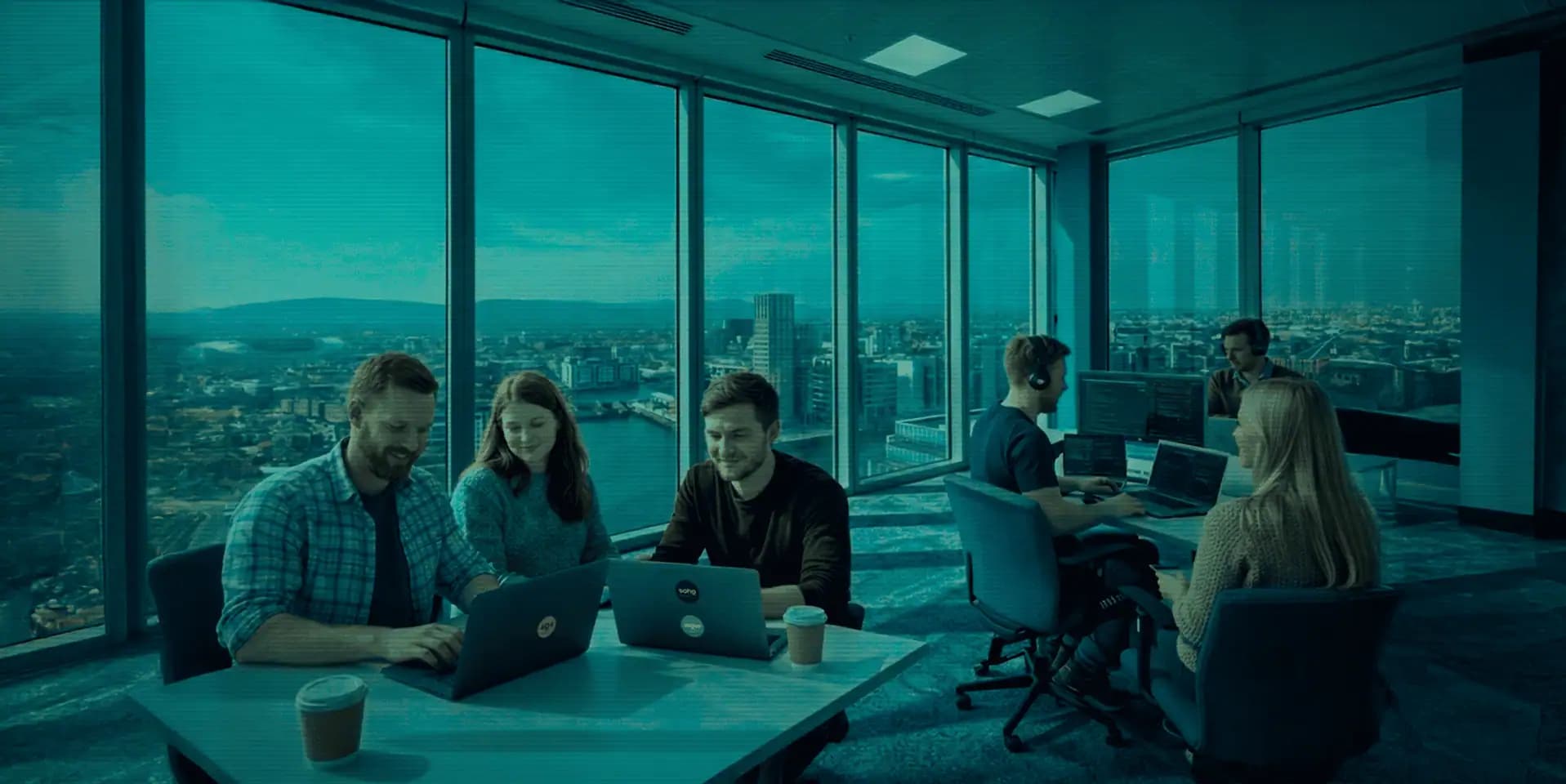 Soho Europe team working in a Dublin office overlooking the city skyline